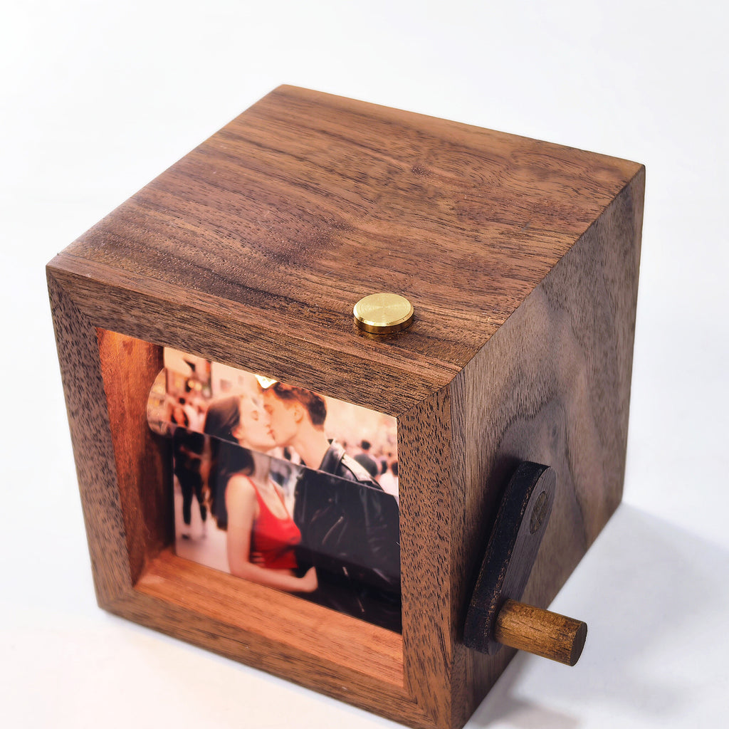 Walnut flip book photo box with a hand crank showing a couple photo