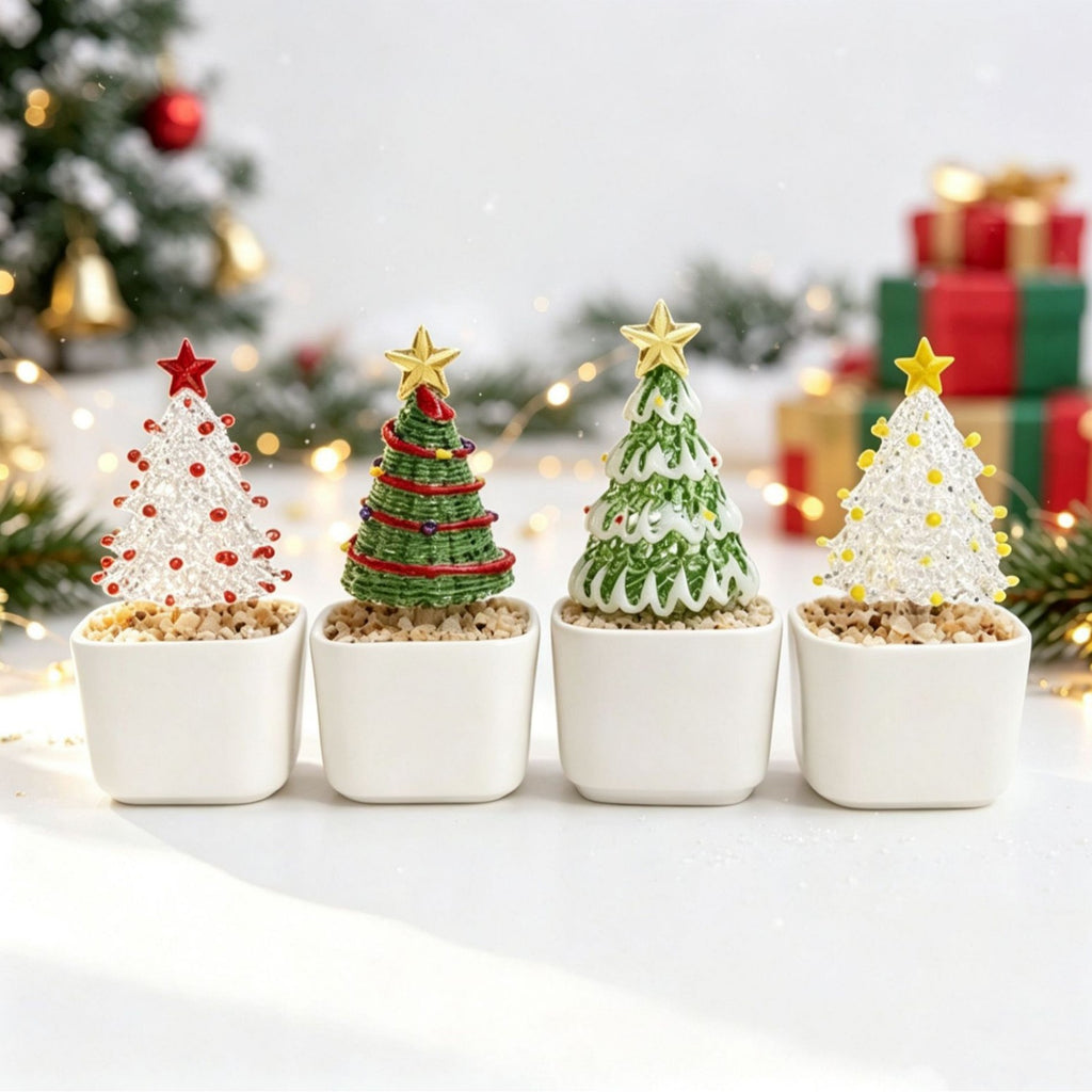 Four mini glass Christmas trees in white ceramic pots