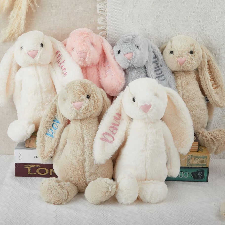 Plush bunnies with names embroidered on their ears