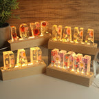 Resin word lamps with dried flowers spelling LOVE, MAMA, DAD and MOM