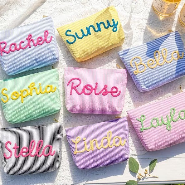 Seersucker makeup bags with names stitched in chenille script