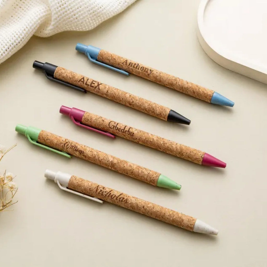 Cork pens engraved with names in different colors