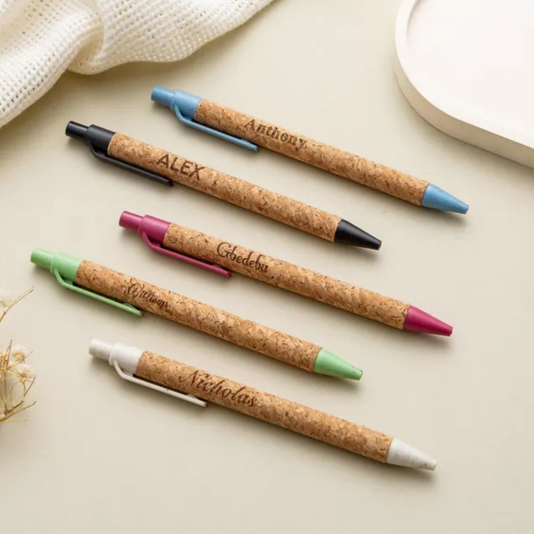 Cork pens engraved with names in different colors
