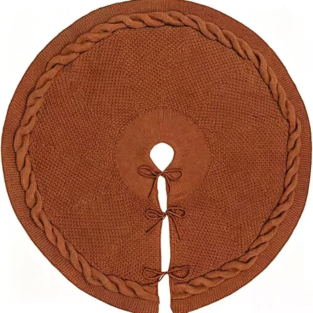 Brown knitted tree skirt with a braided border and bow ties