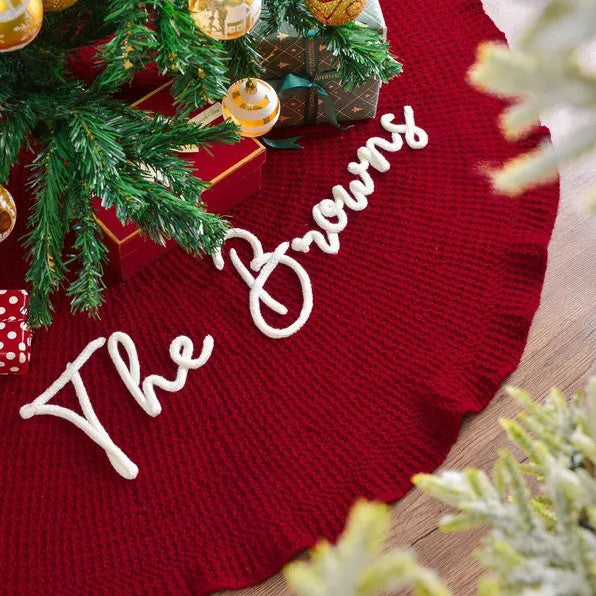 Close-up of The Browns embroidery in raised white script on a red ruffled tree skirt