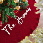 Close-up of The Browns embroidery in raised white script on a red ruffled tree skirt