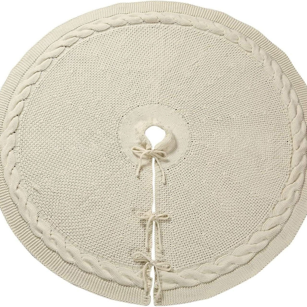 Cream cable-knit tree skirt laid flat with its ties and trunk opening