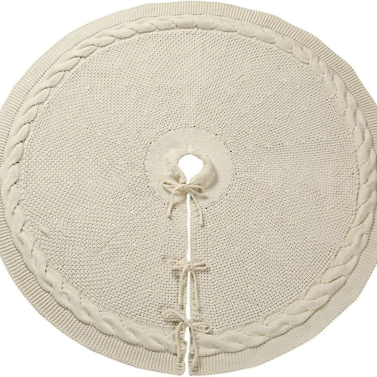 Cream cable-knit tree skirt laid flat with its ties and trunk opening