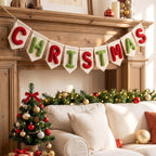Canvas flag banner spelling CHRISTMAS in red and green yarn letters over a fireplace