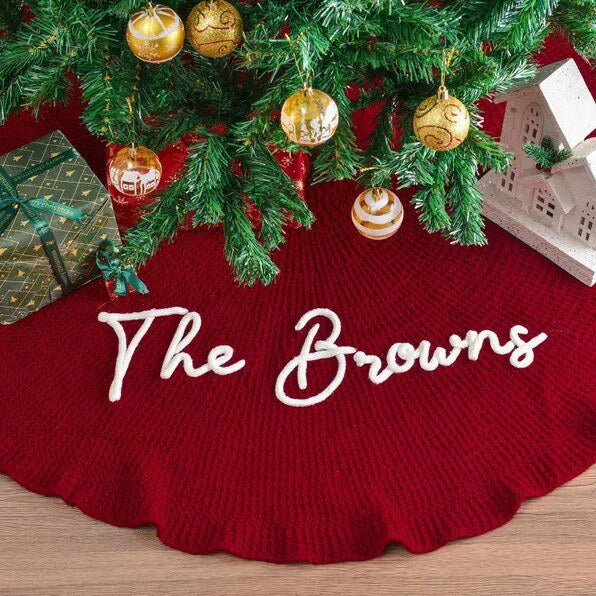 Red knitted tree skirt embroidered with The Browns under a Christmas tree