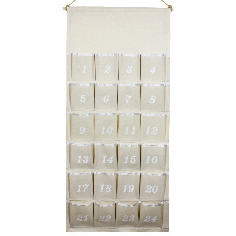 Fabric advent calendar with natural trim and 24 empty pockets on a wooden rod
