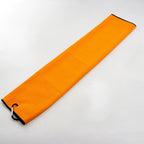 Orange golf towel with a dark trim and clip