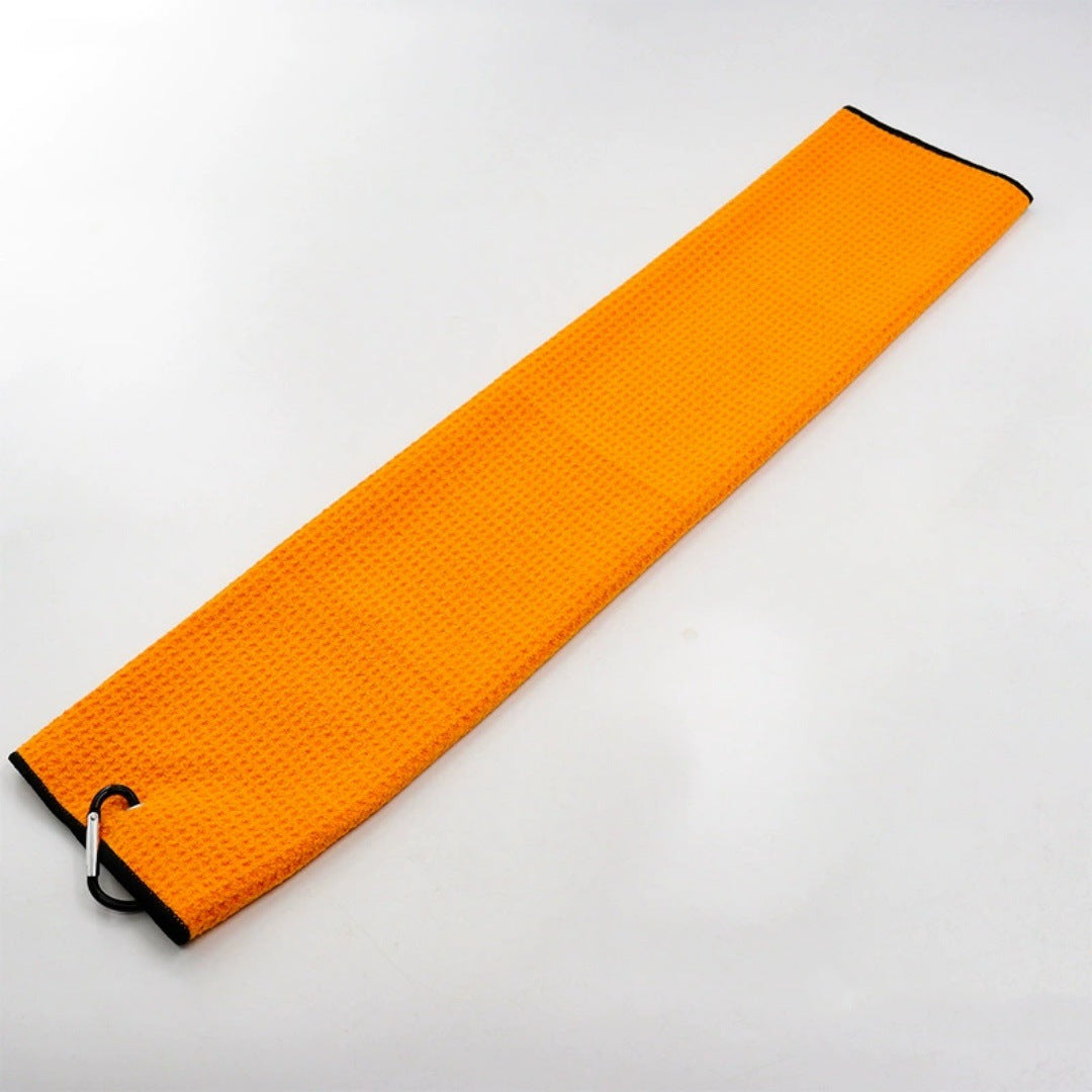Orange golf towel with a dark trim and clip