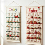 Two personalized advent calendars embroidered with the names Daisy and Myles, pockets filled with small treats