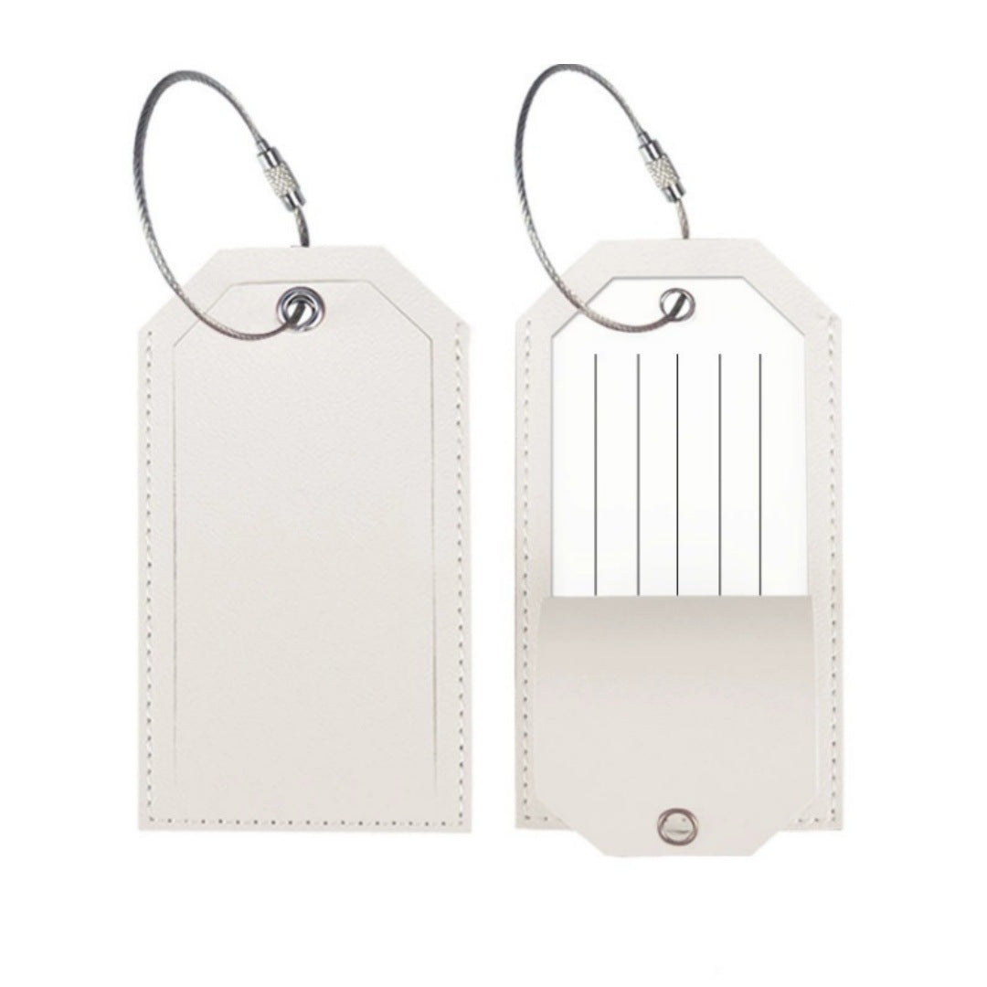 White leather-look luggage tag with a stitched border and an address card